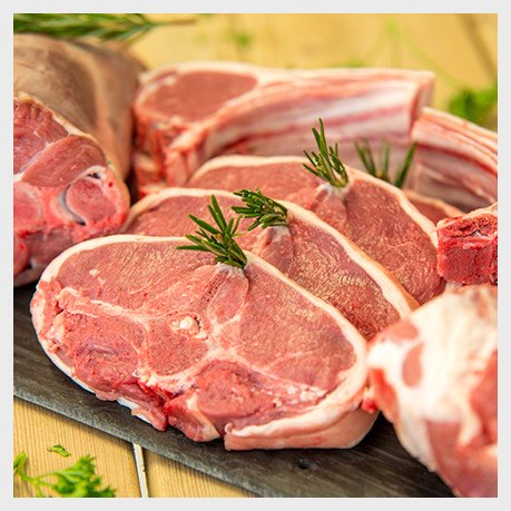 Fresh lamb chops and cuts with rosemary laid out on the block at Hall Farm Butchers, Framlingham
