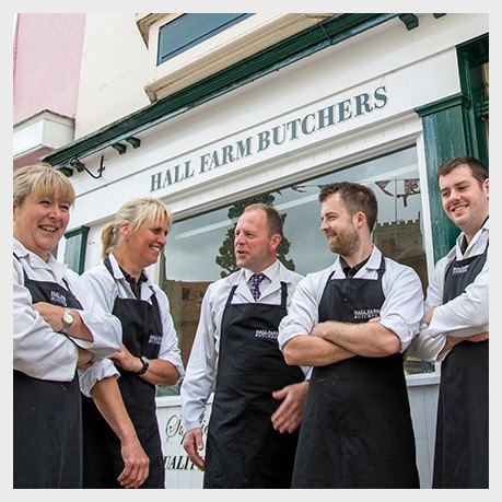 The team outside the green shopfront, number 25, in the market square.